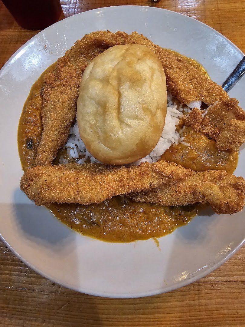 Southern food served on simple white plates.